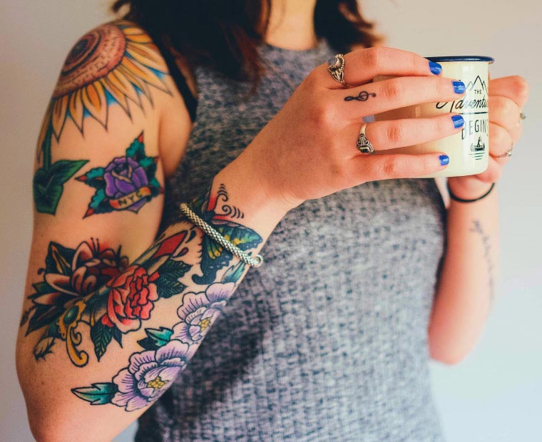 Woman with Tattooed Arm Drinking Coffee Woman with Tattooed Arms Drinking Coffee